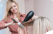Stylist blow-drying a client's hair